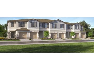 New townhouses with attached garages and well-manicured lawns at 2634 Sunray Venus Way, Ruskin, FL 33570