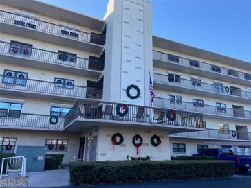 Building exterior featuring a multi-story building with balconies and landscaping at 8198 Terrace Garden N Dr # 407, St Petersburg, FL 33709