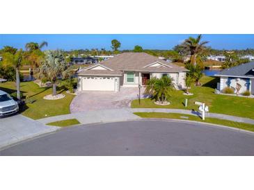 Aerial view of a single-Gathering home with a spacious backyard and water access at 8680 Quinn Ct, North Port, FL 34287