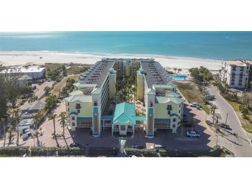 Aerial view of beachfront condo building with pool and parking at 12000 Gulf Blvd # 212-N, Treasure Island, FL 33706