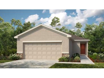 Single-story home with a two-car garage and landscaped front yard at 5803 Laurelcrest Gln, Palmetto, FL 34221
