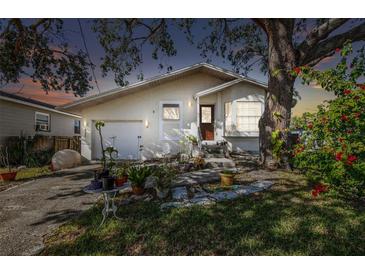 Inviting house exterior at dusk with well-maintained landscaping at 7403 S Swoope St, Tampa, FL 33616