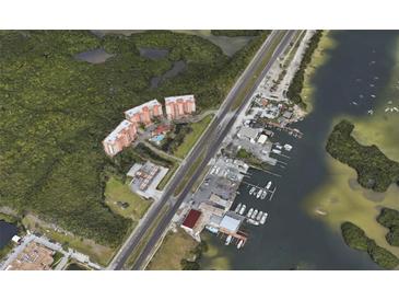 Aerial view of waterfront condo community with pool and boat slips at 12055 Gandy N Blvd # 231, St Petersburg, FL 33702