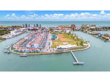 Aerial view of waterfront community with tennis courts and playground at 259 Medallion Blvd # B, Madeira Beach, FL 33708