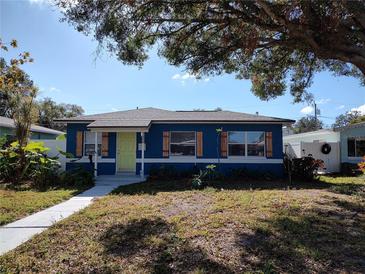 Charming blue house with a green door and landscaped yard at 1644 24Th N Ave, St Petersburg, FL 33713