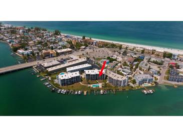 Aerial view of waterfront property with community pool and boat slips at 9815 Harrell Ave # 302, Treasure Island, FL 33706