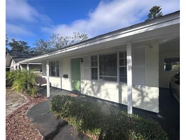 Charming single-story home featuring a covered porch and a well-maintained front yard with lush landscaping at 8153 22Nd N Ave, St Petersburg, FL 33710