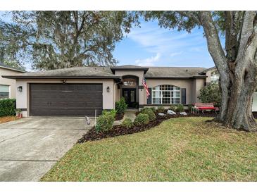 Single-story home with a two-car garage and landscaped yard at 3109 Ohara Dr, New Port Richey, FL 34655