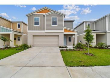 Two-story home with a paved driveway and landscaped front yard at 7624 Starflower Way, Wesley Chapel, FL 33545