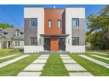 Modern townhome with sleek architectural design, professional landscaping, and inviting curb appeal at 1412 S Moody Ave # A, Tampa, FL 33629