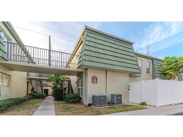 Building exterior showcasing walkway, landscaping, and building features at 1799 N Highland Ave # 28, Clearwater, FL 33755