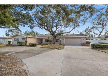 Single-story home with circular driveway and mature landscaping at 289 Rafael Ne Blvd, St Petersburg, FL 33704