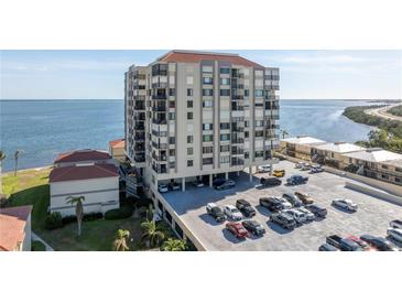 Aerial view of waterfront condo building with parking and surrounding landscape at 6372 Palma Del Mar S Blvd # 505, St Petersburg, FL 33715