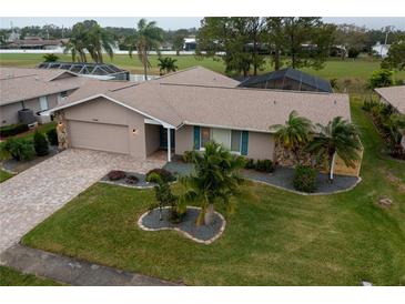 Single-story home with a landscaped yard and driveway at 6760 Burning Tree Dr, Seminole, FL 33777