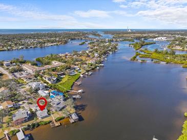 Aerial view of waterfront home with private dock and boat access at 420 Doric Ct, Tarpon Springs, FL 34689