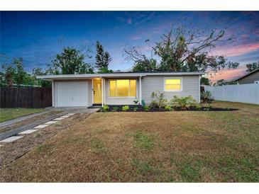 Charming single-story home with a well-manicured lawn, attached garage, and inviting curb appeal at 6524 14Th N St, St Petersburg, FL 33702