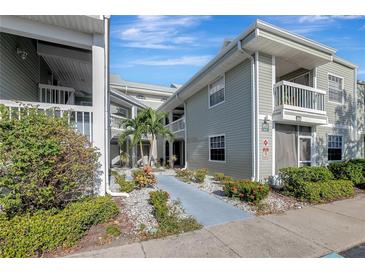 Inviting condo exterior with lush landscaping and a paved walkway at 6923 Stonesthrow N Cir # 4105, St Petersburg, FL 33710
