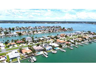 Stunning aerial view of a waterfront home in a luxurious community at 11300 7Th E St, Treasure Island, FL 33706