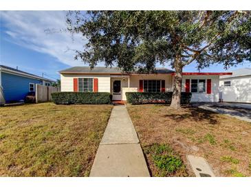 Charming single-story home with red shutters and a landscaped front yard at 2008 Culberson Ave, Dunedin, FL 34698