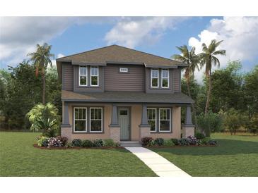 Inviting two-story home with a manicured lawn, lush landscaping, and charming architectural details at 853 53Rd N Ave, St Petersburg, FL 33703
