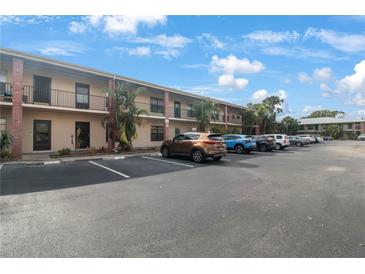 Exterior view of condo building with ample parking at 970 85Th N Ave # 209, St Petersburg, FL 33702