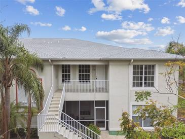 Charming two-story condo with a private balcony, palm trees, and white trim at 2632 River Preserve Ct, Bradenton, FL 34208