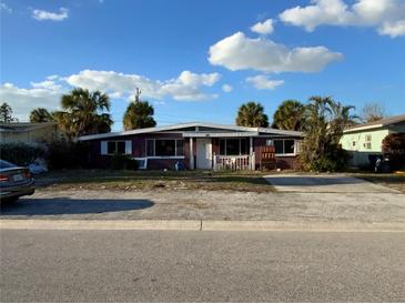 One-story home with a driveway and front yard at 415 86Th Ave, St Pete Beach, FL 33706