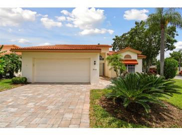 Charming single-story home with a red tile roof and a well-manicured front yard at 4327 Murfield E Dr, Bradenton, FL 34203
