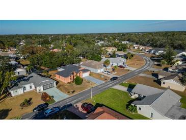 Aerial view of a residential neighborhood with houses and trees at 4401 Plumosa St, Spring Hill, FL 34607
