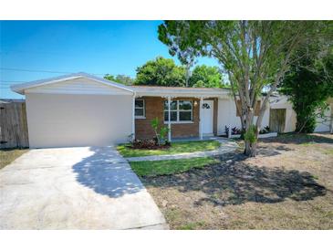 Charming single-story home with a brick facade and landscaped front yard at 8391 76Th Ave, Seminole, FL 33777