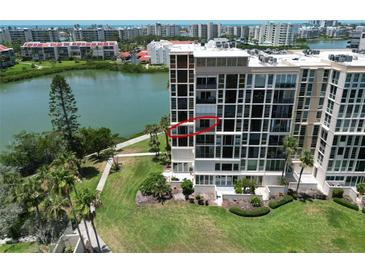 Luxury high-rise with a beautiful view of the water, manicured lawn, and mature palm trees in a desirable coastal location at 7400 Sun Island Dr # 501, South Pasadena, FL 33707