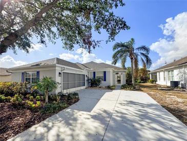Charming single-story home with mature landscaping, a large driveway, and a screened-in garage, perfect for Florida living at 1333 Misty Greens Dr, Sun City Center, FL 33573