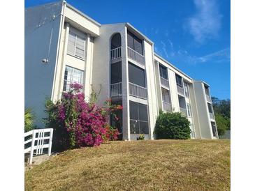 Two-story condo building with landscaped grounds at 2625 State Road 590 # 2824, Clearwater, FL 33759