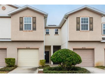 Front view of a modern two-story townhome with attached garages at 4770 White Sanderling Ct, Tampa, FL 33619