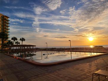 Refreshing community pool at sunset with ocean view at 880 Mandalay Ave # C314, Clearwater Beach, FL 33767