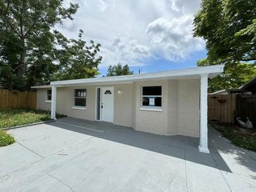Renovated single-story home with a covered entryway and driveway at 5038 Galaxy Dr, New Port Richey, FL 34652