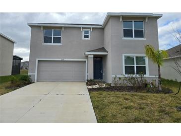 Two-story home with a two-car garage and landscaped front yard at 8379 Ender Hills Dr, Wesley Chapel, FL 33545