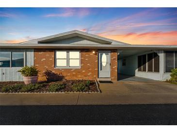 Brick front exterior of charming single story home with landscaped yard at 12400 Park Blvd # 213, Seminole, FL 33772