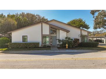 Updated condo with modern exterior, landscaping, and curb appeal at 1836 Cypress Trace Dr, Safety Harbor, FL 34695