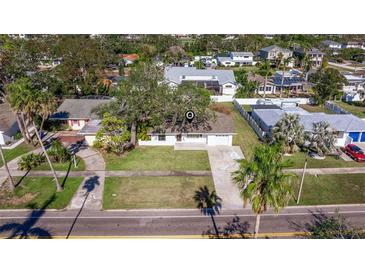 An aerial view of a single-Gathering home with a driveway and lush landscaping at 930 Snell Isle Ne Blvd, St Petersburg, FL 33704