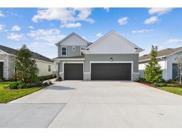 Charming two-story home with a three-car garage and beautiful landscaping at 11846 Mile Marsh Dr, Riverview, FL 33569