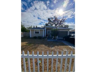 Single-story home with white picket fence and attached garage at 4150 15Th S Ave, St Petersburg, FL 33711