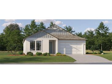 One-story home with gray and white siding, a two-car garage, and landscaping at 7504 E 116Th St, Palmetto, FL 34221