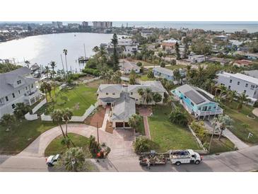 Aerial view of waterfront home with large lot and circular driveway at 15825 Redington Dr, Redington Beach, FL 33708