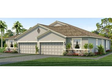 Two-story house with gray siding, three-car garage, and landscaping at 2375 Warren Acres Blvd, Wesley Chapel, FL 33543