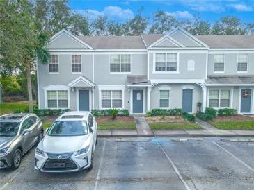 Two-story townhome with gray siding, two parking spaces, and landscaping at 2432 Lake Woodberry Cir # 2432, Brandon, FL 33510
