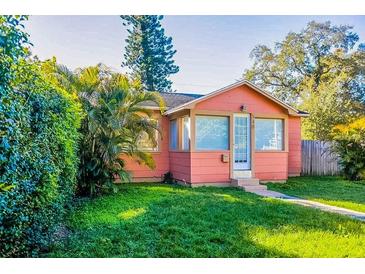 Charming pink bungalow with well-maintained lawn and hedges at 540 Newton S Ave, St Petersburg, FL 33701