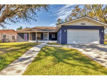Ranch style home with a two-car garage and well-manicured lawn at 1040 31St E St, Palmetto, FL 34221