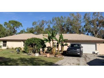 Single story home with a well-maintained lawn and attached garage at 37210 Bermont Rd, Punta Gorda, FL 33982