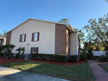 Brick building with landscaping and parking at 21038 Voyager Blvd # 4, Land O Lakes, FL 34638